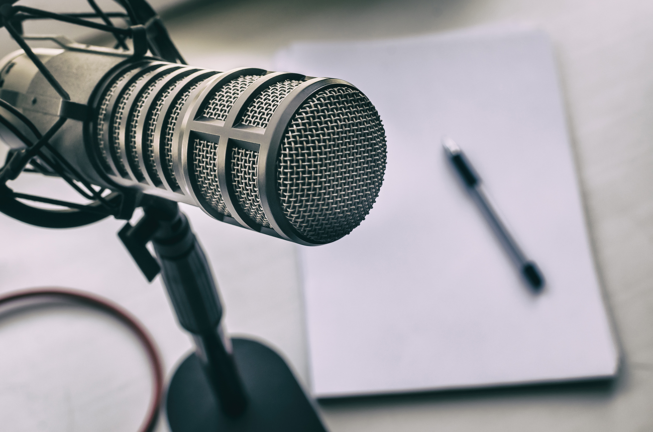 podcast microphone and transcription notepad