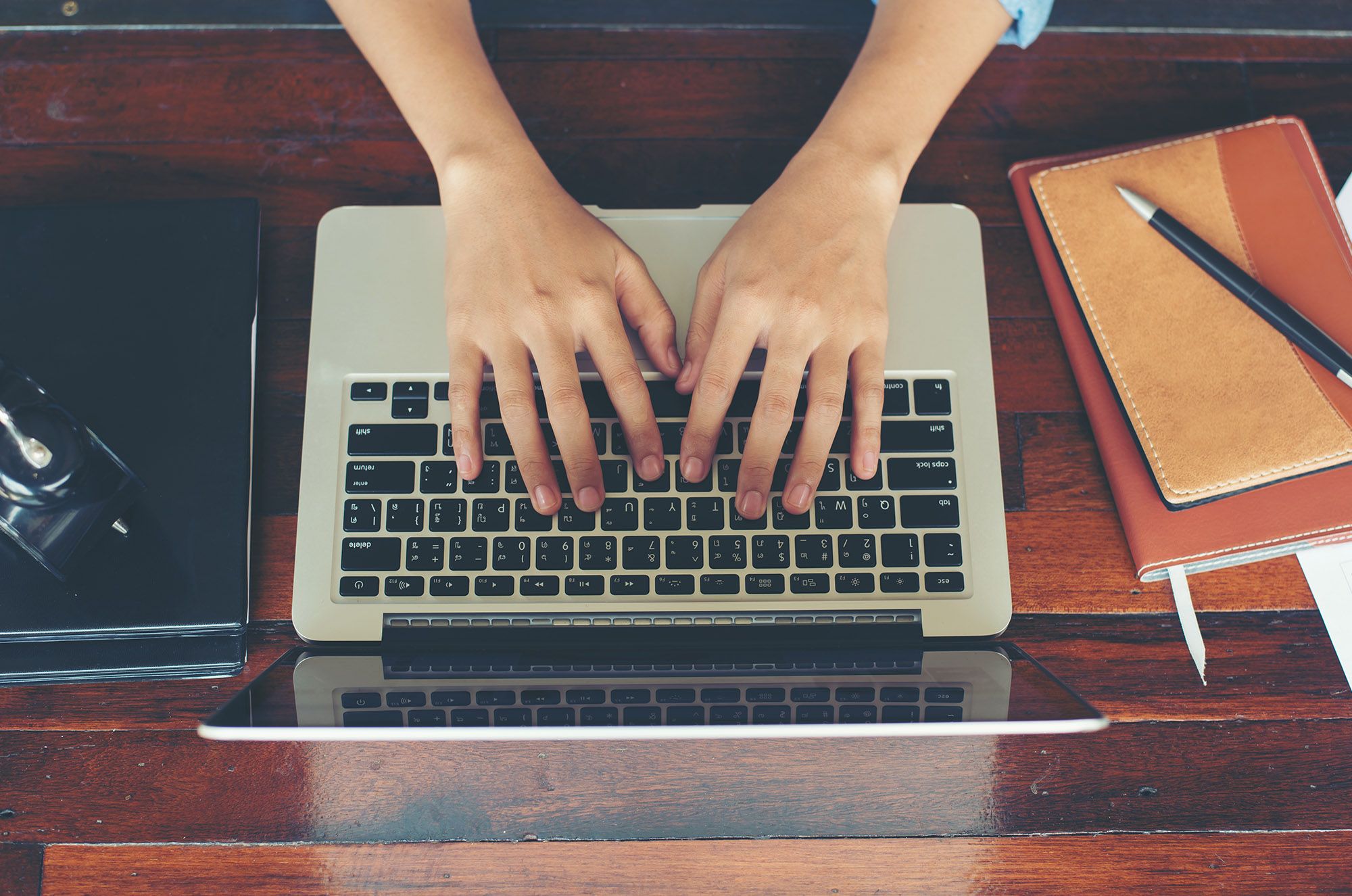 woman typing on her laptop